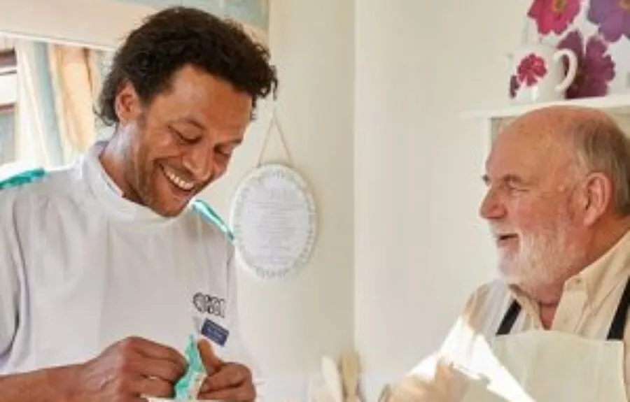 A nurse talking to an elderly nursing home resident - Maven Healthcare