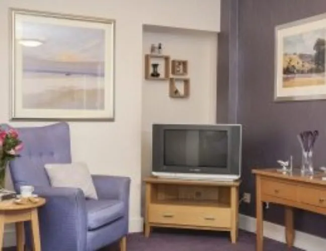 Living area with television at North Court care home - Maven Healthcare