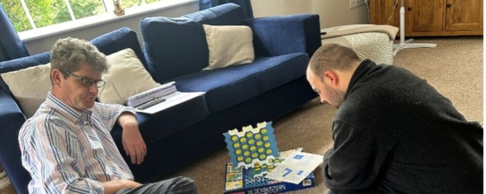 Care home residents play connect 4 at Inclusive Support - Maven Healthcare