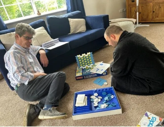 Care home residents play connect 4 at Inclusive Support - Maven Healthcare