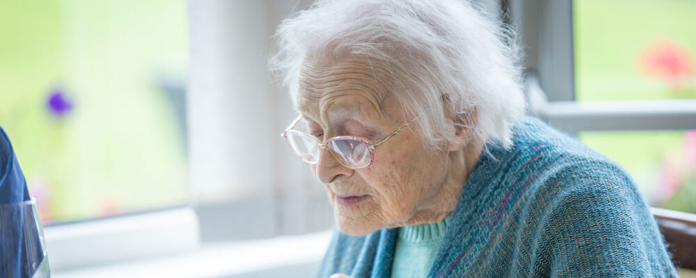 Elderly lady eating breakfast at St Oswalds care home - Maven Healthcare