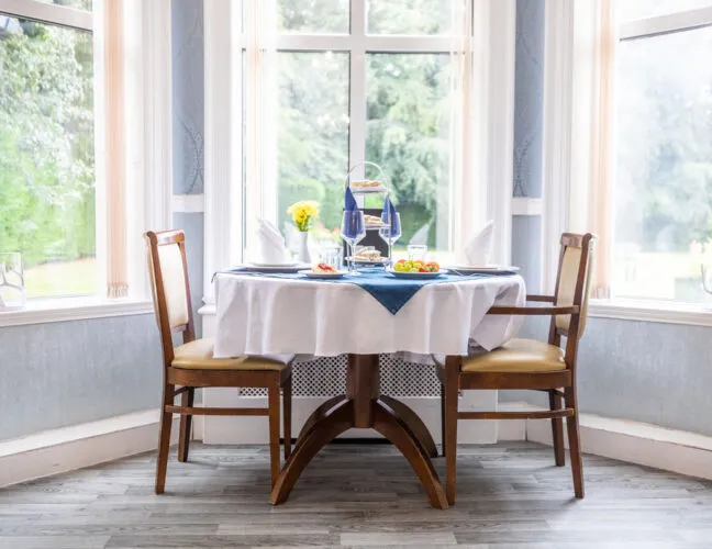 Dining table in a light room at St Oswalds House care home in Warrington - Maven Healthcare