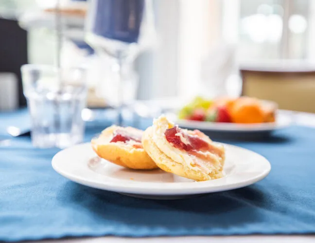 Scone with cream and jam at St Oswalds House care home, Warrington - Maven Healthcare