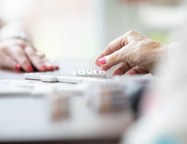 Two ladies playing dominoes at residential care home in Warrington - Maven Healthcare